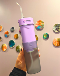 an image of optimal dental healths purple ozone water floss for antibacterial and anti inflammatory benefits